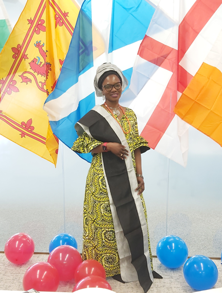 Omon stood in front of some flags